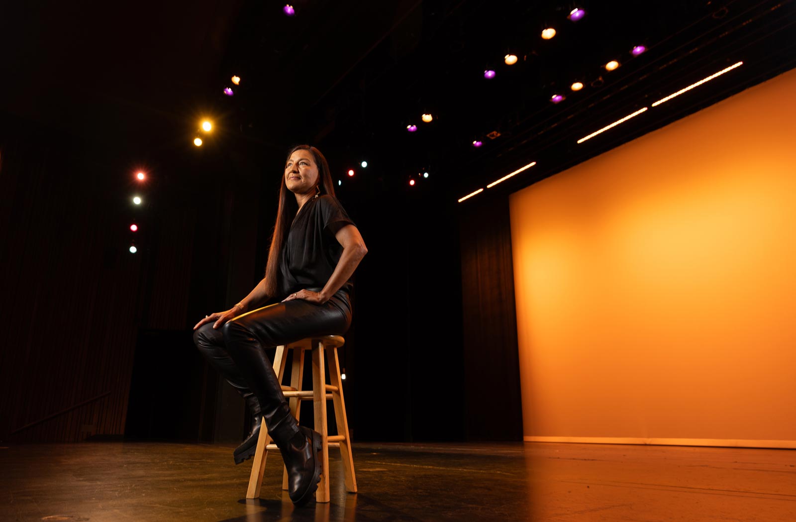 Kimberly Guerrero sits on a stage.