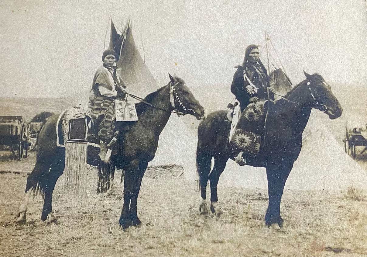 A vintage photo of Kimberly's grandparents in Native American regalia while on horseback.
