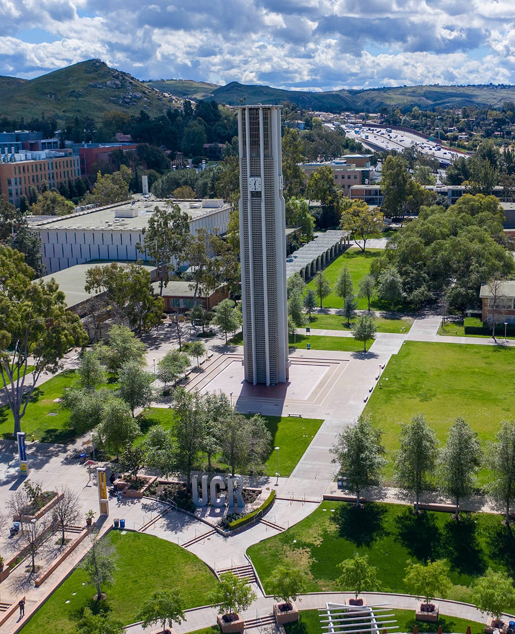 Aerial view of UC Riverside campus with bell tower and UCR letters