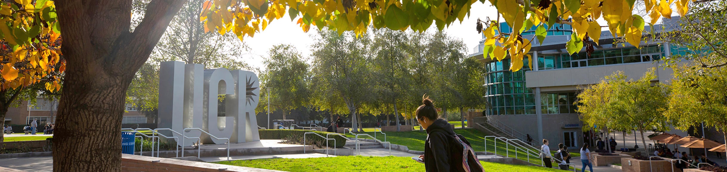 Student walking on campus near the HUB