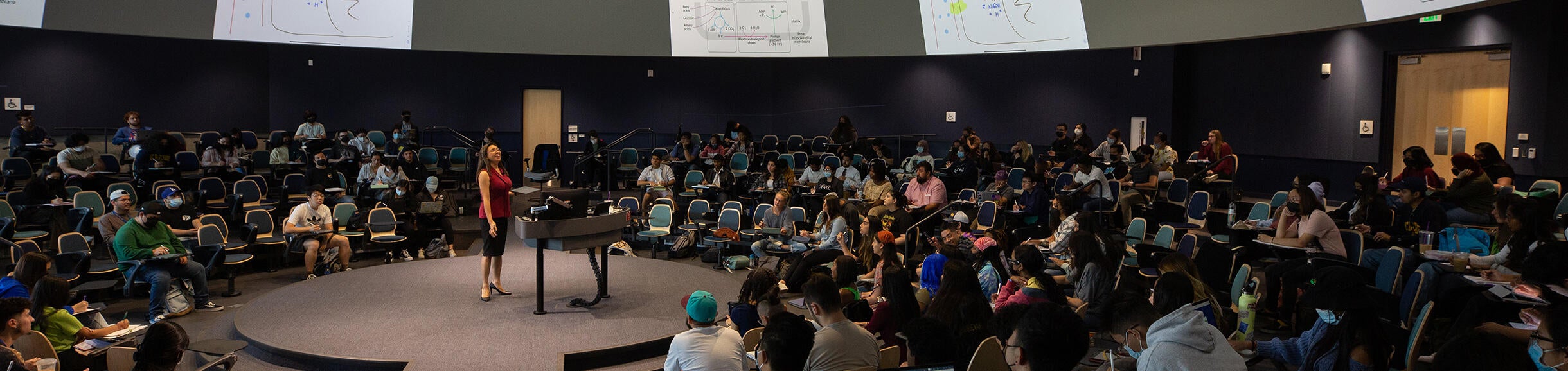 UCR Professor teaching inside of the Student Success Center lecture hall