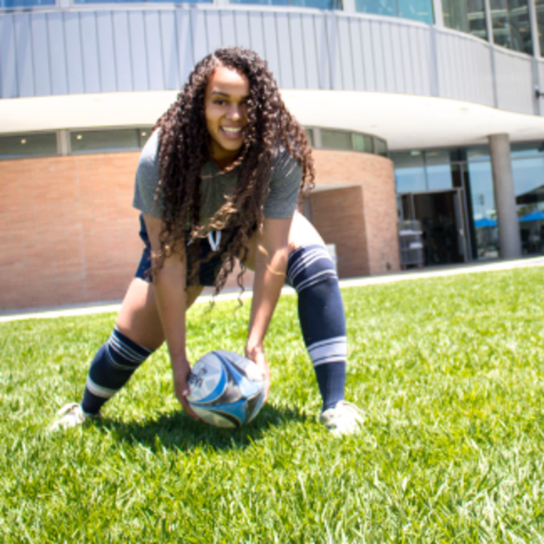 girl holding soccer ball