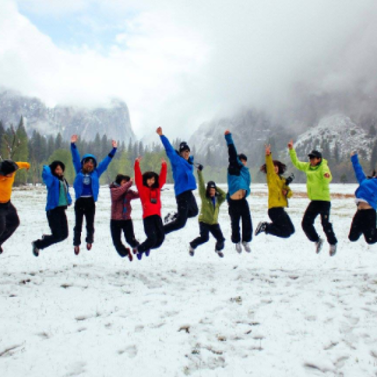 students in snow jumping