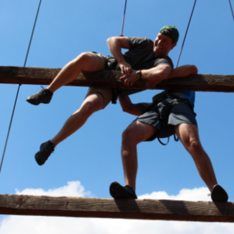 two men working together in a ropes course