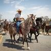 Felipe Ortiz (front) and other Bloomington community members demonstrating against residential displacement by warehouse development during a cabalgata (horse parade).