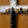 Pastor Percy Harper, reflected in a mirrored cross, delivers a sermon at St. Mark’s.