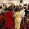 Congregants pray together during a service at St Mark’s.