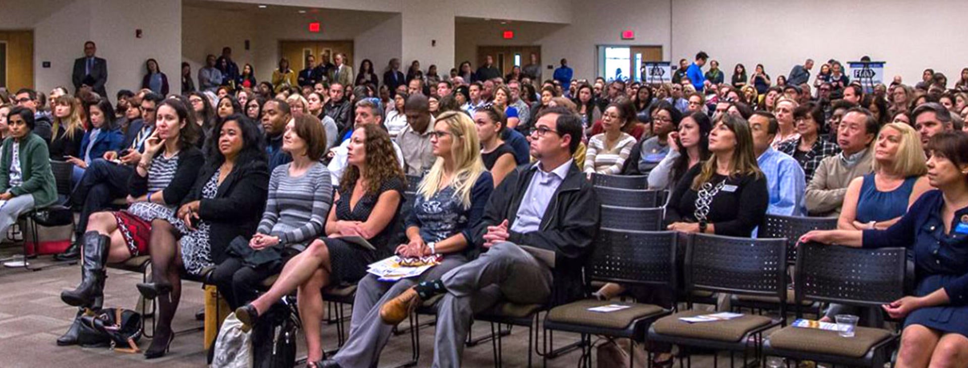 a large audience of people listening to speaker