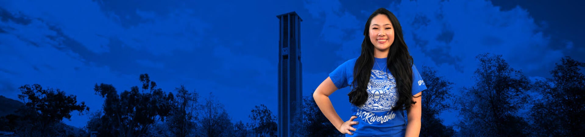 UCR student with the bell tower and campus as the background
