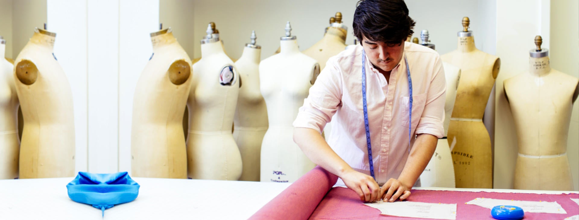 Student cutting fabric